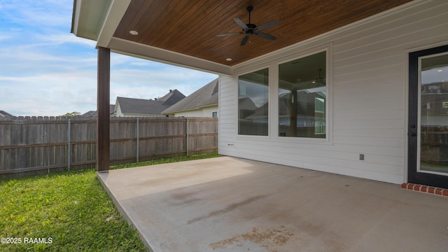 view of patio / terrace with ceiling fan and fence