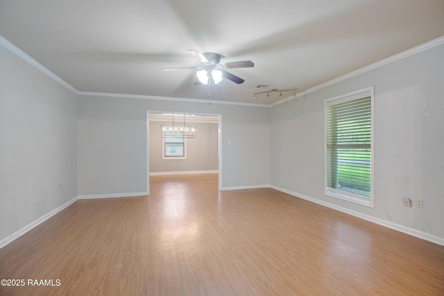 1621 Elm St, New Iberia, LA 70560 - empty room featuring rail lighting, light wood-type flooring, baseboards, ceiling fan with notable chandelier, and ornamental molding