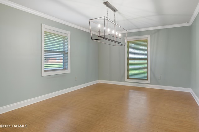 1621 Elm St, New Iberia, LA 70560 - spare room with ornamental molding, wood finished floors, a notable chandelier, and a healthy amount of sunlight