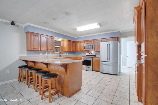 1621 Elm St, New Iberia, LA 70560 - kitchen with a kitchen breakfast bar, light tile patterned floors, a peninsula, ornamental molding, and stainless steel appliances