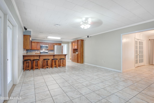 1621 Elm St, New Iberia, LA 70560 - kitchen featuring crown molding, brown cabinetry, a peninsula, ceiling fan, and stainless steel appliances