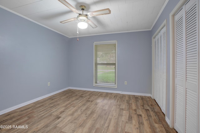 1621 Elm St, New Iberia, LA 70560 - unfurnished bedroom with crown molding, a ceiling fan, baseboards, and wood finished floors