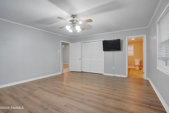 1621 Elm St, New Iberia, LA 70560 - unfurnished bedroom featuring baseboards, ornamental molding, a closet, and light wood finished floors