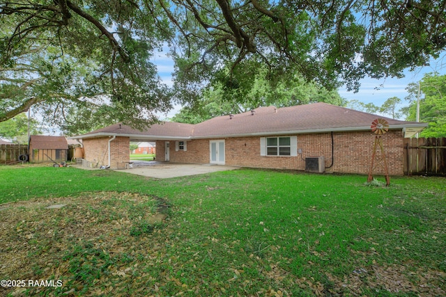1621 Elm St, New Iberia, LA 70560 - rear view of house with brick siding, fence, a patio area, and a storage unit