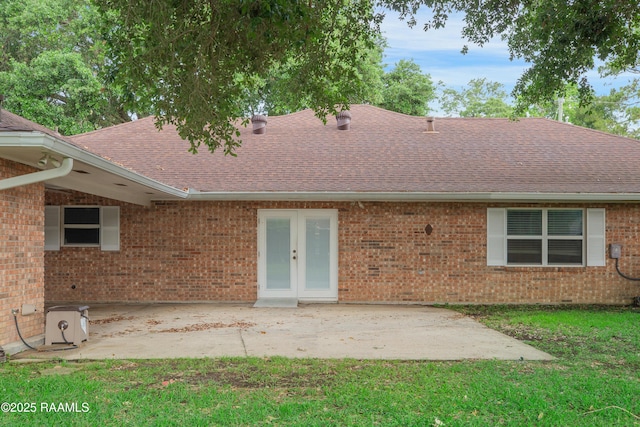 1621 Elm St, New Iberia, LA 70560 - back of house with french doors, brick siding, a shingled roof, a patio area, and a lawn