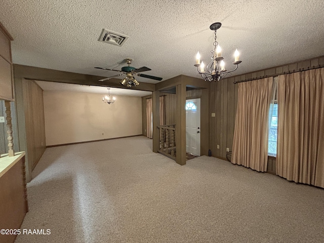 unfurnished room with visible vents, a textured ceiling, baseboards, and a chandelier