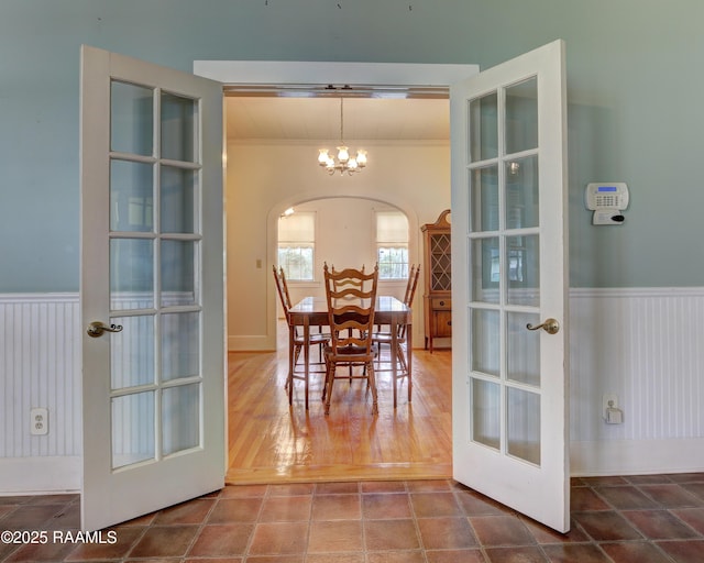 627 Weeks St, New Iberia, LA 70560 - dining space with arched walkways, wainscoting, a chandelier, and ornamental molding