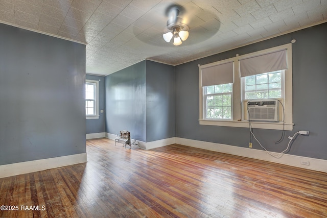 627 Weeks St, New Iberia, LA 70560 - spare room with wood-type flooring, cooling unit, ceiling fan, and baseboards
