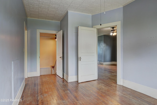 627 Weeks St, New Iberia, LA 70560 - spare room with wood-type flooring, ornamental molding, baseboards, and ceiling fan
