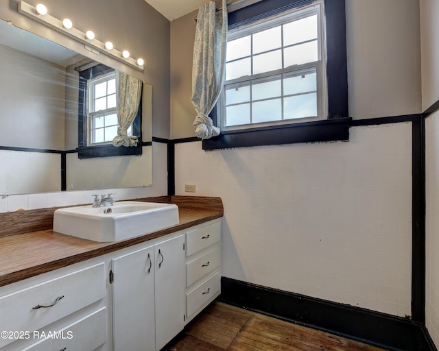 627 Weeks St, New Iberia, LA 70560 - bathroom featuring vanity, wood finished floors, and a wainscoted wall