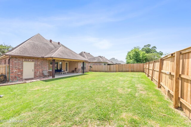 view of yard featuring a fenced backyard and a patio area