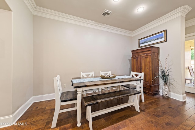 dining area with baseboards, ornamental molding, and hardwood / wood-style flooring