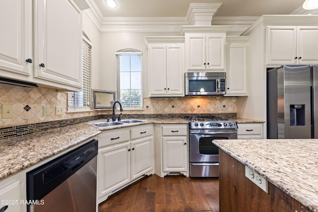 kitchen featuring ornamental molding, white cabinetry, a sink, dark wood finished floors, and appliances with stainless steel finishes