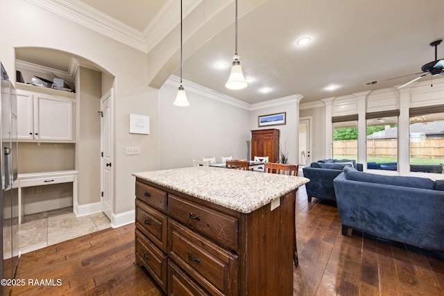 kitchen featuring open floor plan, visible vents, ornamental molding, and dark wood-type flooring