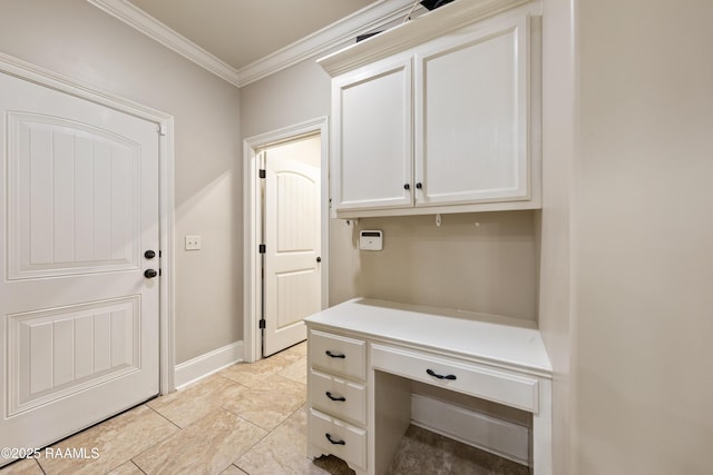 interior space featuring built in study area, ornamental molding, and baseboards