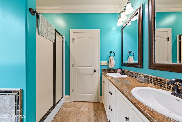 full bath with double vanity, a sink, a stall shower, and ornamental molding