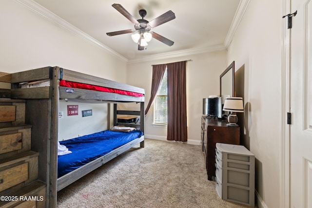 carpeted bedroom with a ceiling fan, baseboards, and ornamental molding