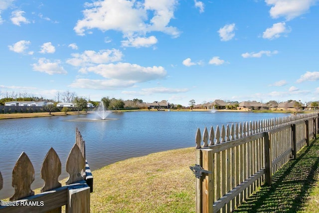 property view of water with fence and a residential view