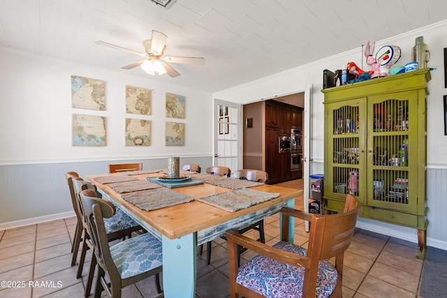 492 Kent St, Breaux Bridge, LA 70517 - dining room featuring ornamental molding, a ceiling fan, wainscoting, and light tile patterned floors