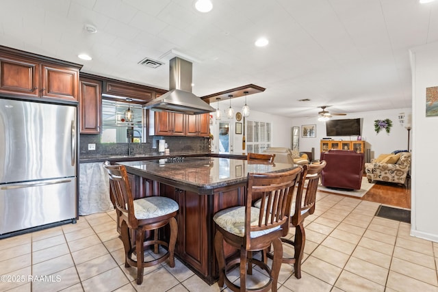 492 Kent St, Breaux Bridge, LA 70517 - kitchen featuring freestanding refrigerator, island range hood, a sink, a ceiling fan, and a center island