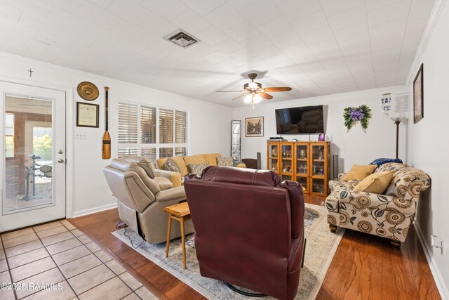 492 Kent St, Breaux Bridge, LA 70517 - living area with crown molding, ceiling fan, light wood finished floors, and baseboards