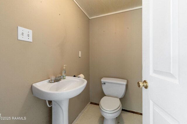 492 Kent St, Breaux Bridge, LA 70517 - bathroom featuring toilet, tile patterned floors, and baseboards