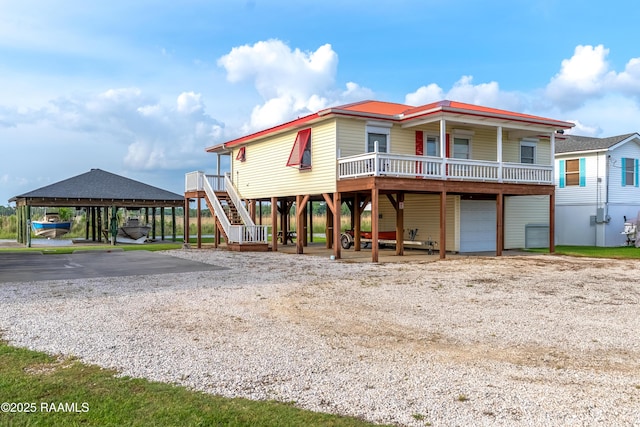 4998 Airhart Rd Unit A, Lake Charles, LA 70605 - coastal inspired home featuring stairway, an attached garage, driveway, and a wooden deck