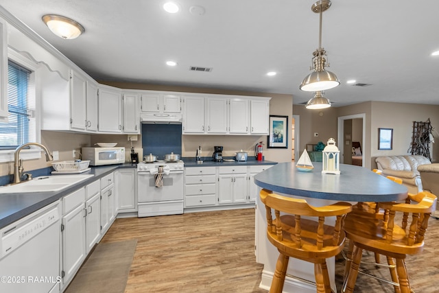 4998 Airhart Rd Unit A, Lake Charles, LA 70605 - kitchen with visible vents, dark countertops, white appliances, white cabinets, and a sink