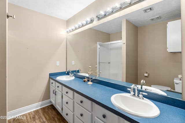 4998 Airhart Rd Unit A, Lake Charles, LA 70605 - bathroom featuring a sink, wood finished floors, a stall shower, and toilet