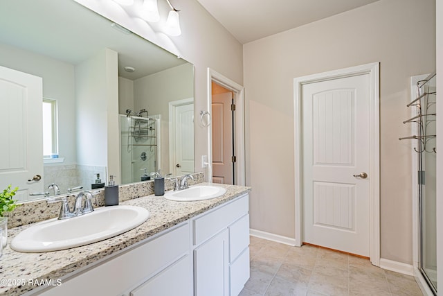 full bathroom with double vanity, tile patterned floors, a sink, and a stall shower