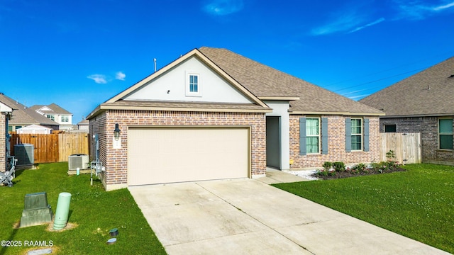 view of front of home featuring brick siding, fence, a front yard, and concrete driveway