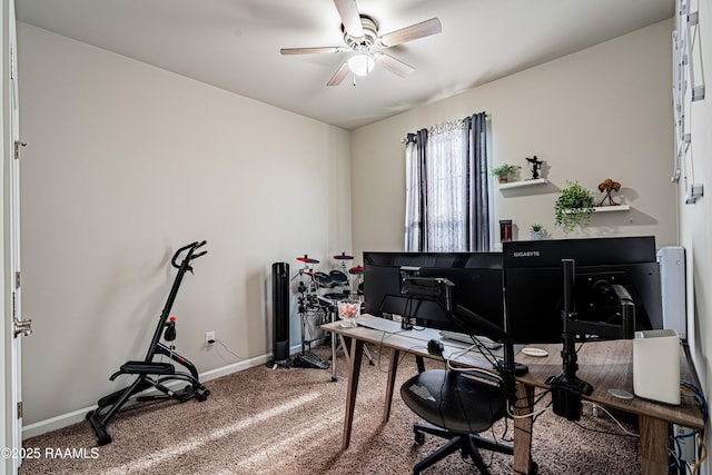office space with baseboards, ceiling fan, and carpet