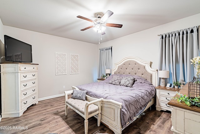 bedroom with baseboards, ceiling fan, and wood finished floors