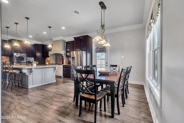 dining space featuring recessed lighting, visible vents, ornamental molding, and a wealth of natural light