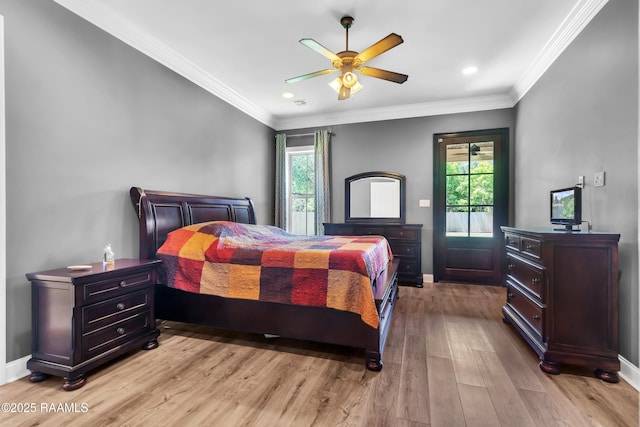 bedroom with baseboards, a ceiling fan, light wood-style flooring, and multiple windows