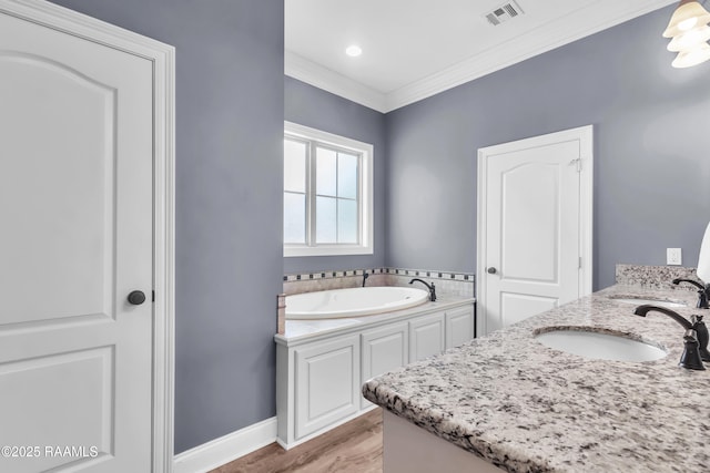 full bath with a sink, a garden tub, wood finished floors, and visible vents