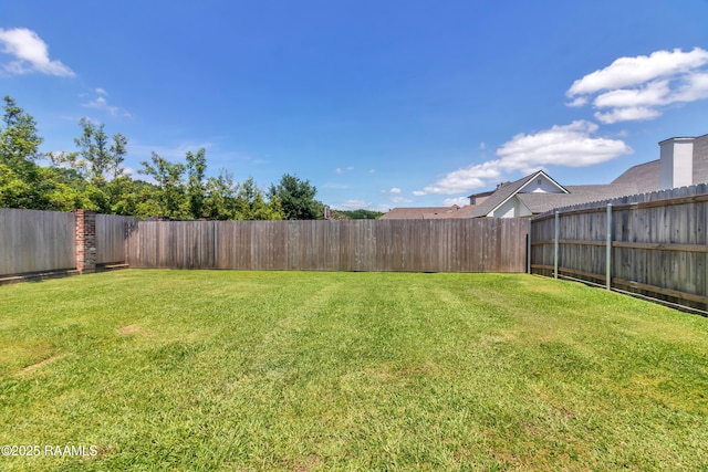 view of yard featuring a fenced backyard