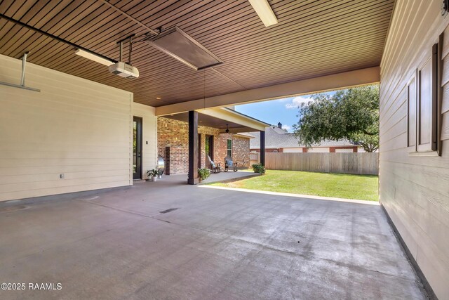 view of patio / terrace with ceiling fan and fence