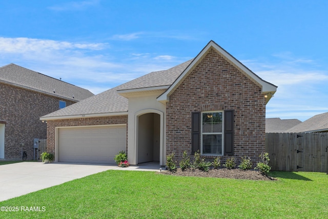 view of front of house featuring a garage, a front lawn, fence, brick siding, and concrete driveway