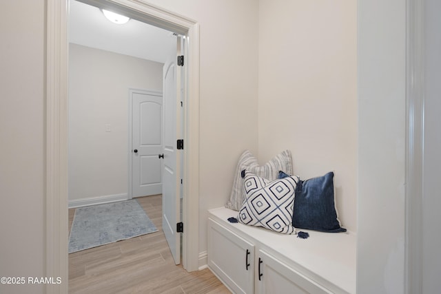 mudroom featuring baseboards and light wood finished floors