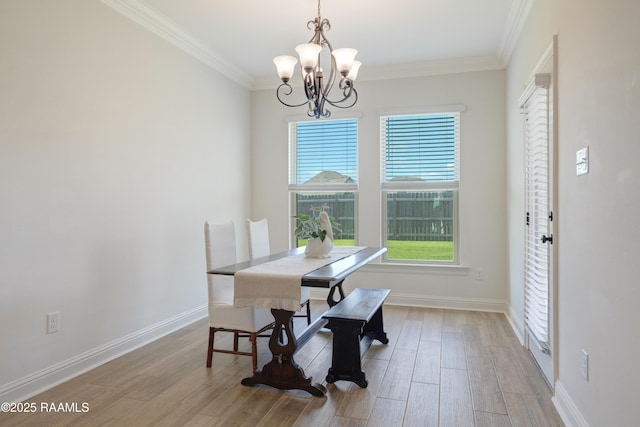 dining space with baseboards, an inviting chandelier, ornamental molding, and wood finished floors
