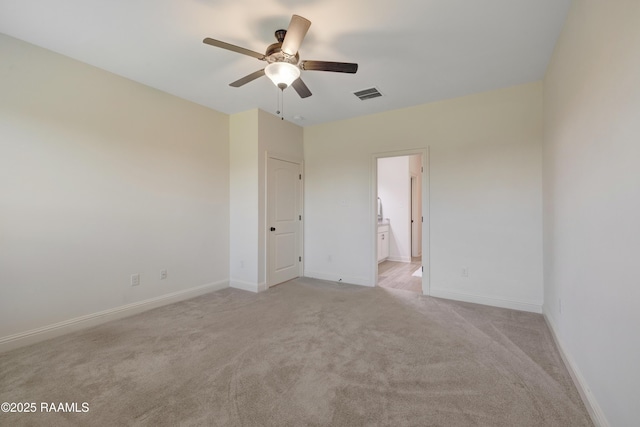 empty room featuring visible vents, a ceiling fan, baseboards, and light colored carpet