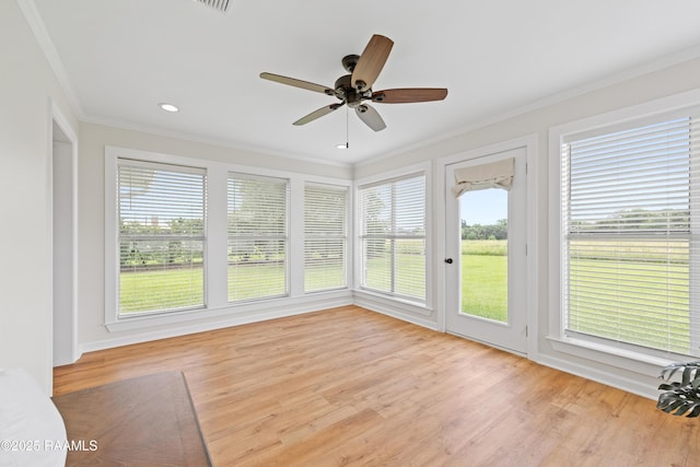 unfurnished sunroom with crown molding, wood finished floors, and recessed lighting