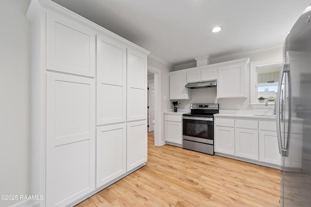 kitchen featuring a sink, stainless steel appliances, ornamental molding, under cabinet range hood, and white cabinets