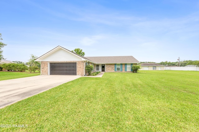 single story home featuring a front yard, concrete driveway, brick siding, and a garage
