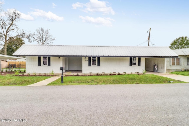 109 W Roosevelt St, Broussard, LA 70518 - ranch-style home with brick siding, metal roof, an attached carport, and driveway