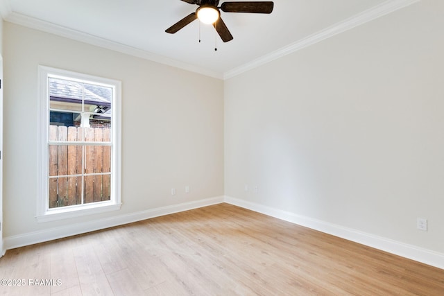 spare room featuring crown molding, a ceiling fan, baseboards, and light wood-style floors