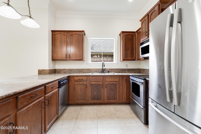 kitchen featuring crown molding, appliances with stainless steel finishes, a sink, dark stone counters, and light tile patterned floors