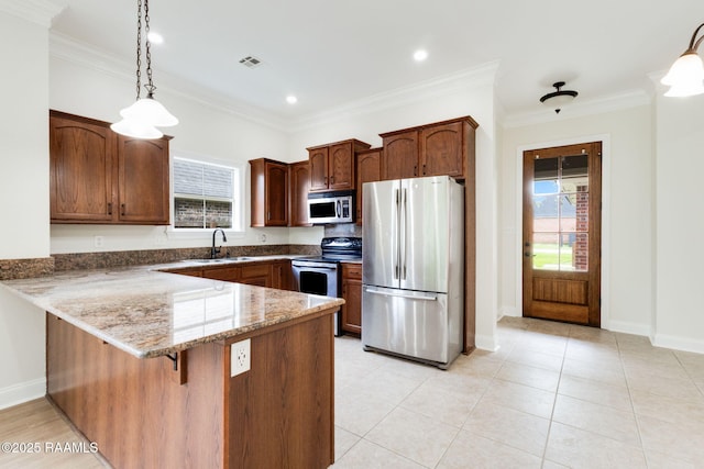 kitchen with a sink, baseboards, a peninsula, dark stone counters, and stainless steel appliances