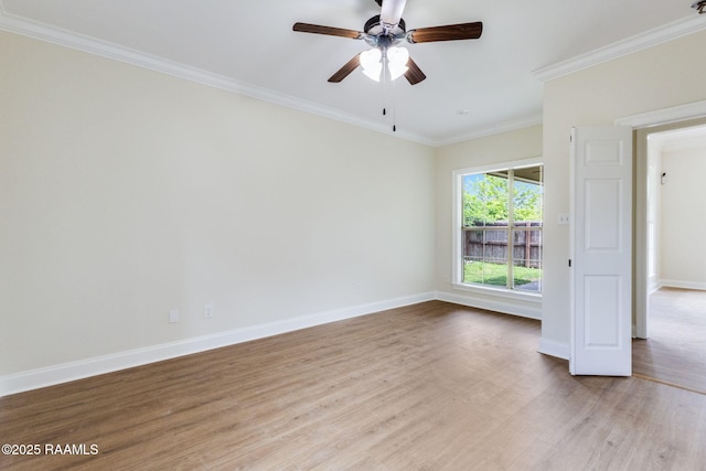 empty room featuring crown molding, baseboards, ceiling fan, and light wood-style flooring